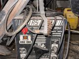 a welding machine sitting on the floor in a garage
