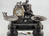 a statue of a woman sitting on a table with a clock on it