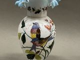 two vases that have birds painted on them