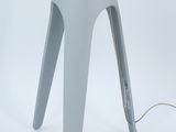 a gray lamp that is sitting on a white table