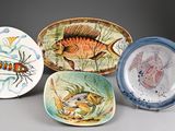 several plates with different designs on them on a gray surface