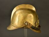 an antique helmet on a stand against a gray background