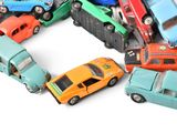 several toy cars are arranged in a circle on a white surface