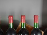 several bottles of wine are lined up in a row on a table