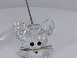 a crystal mouse sitting on top of a white table