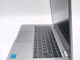 a silver laptop with a blue sticker on the keyboard