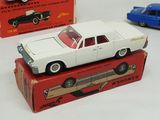 two toy cars that are sitting on top of a box
