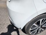a white car parked on the side of the road