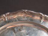 a silver plate with a decorative design on it