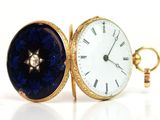 an image of a pocket watch with a diamond in the center