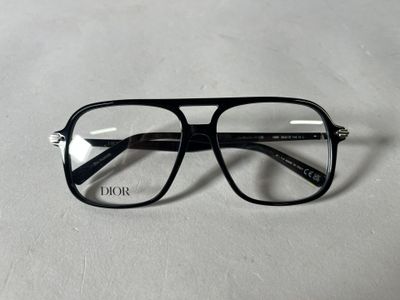 the glasses are black and have a clear lens on them