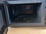 a microwave that is open on a wooden table