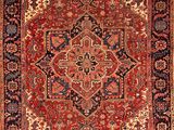 an antique persian rug with a red and blue design