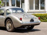 a silver sports car parked in front of a house