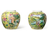 pair of yellow vases decorated with flowers and birds on a white background