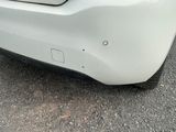 a close up of a car ' s bumper with a dent on it