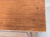 a close up of a wooden table with a drawer underneath it