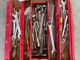 many wrenches in a red box on the floor