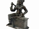 an image of a statue of a woman sitting on top of a box