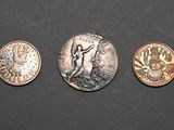three different types of coins are shown on a black surface