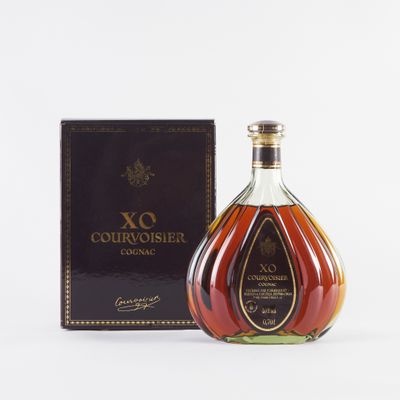 a bottle of courvoisir cognar next to a box