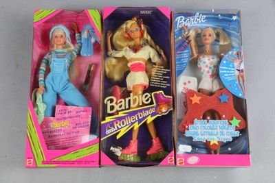 three barbie dolls are in their boxes on a table