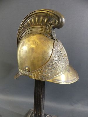 helmet of a roman soldier on a stand on a gray background
