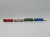 four toy buses lined up in a row on a white surface