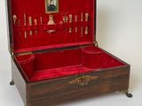 a wooden box with a red velvet lining and gold trim
