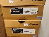 several boxes of shoes stacked on top of each other in a room