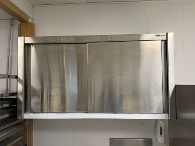 un réfrigérateur en acier inoxydable dans une cuisine dotée d'une fenêtre