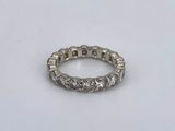 a close up of a diamond ring on a white surface