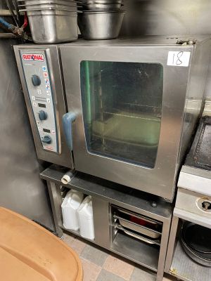 a small oven sitting in the middle of a kitchen