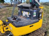 the back end of a yellow bulldozer sitting in a field
