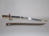 an old sword with a wooden handle on a white surface