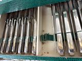 a lot of silverware in a box on a table