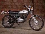 a motorcycle that is parked in front of a brick wall