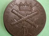 a brown coin with a crown on it on a green surface