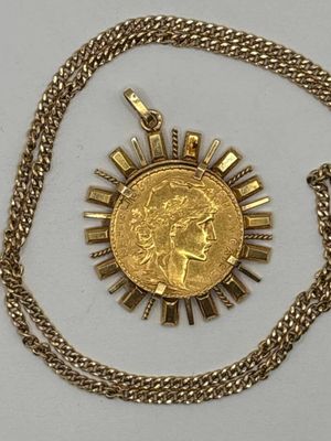 an image of a gold coin with a sunburst on it