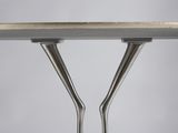 a close up of a metal table with two forks sticking out of it