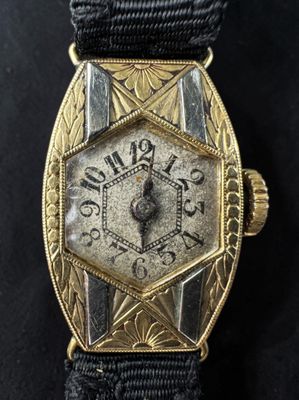 an image of a gold watch with a black strap
