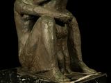 statue of a man and a woman sitting on a marble base