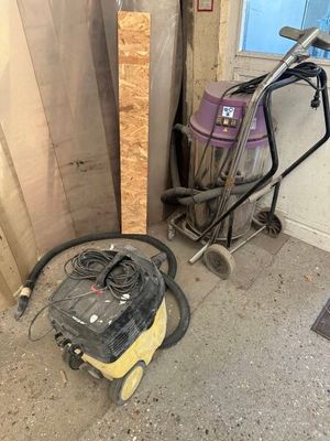 a vacuum and a cart in a room