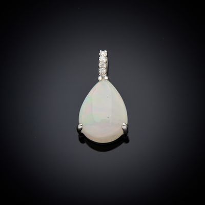 a white oplite and diamond pendant