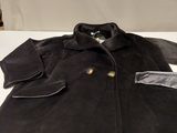 an image of a black coat on a white table