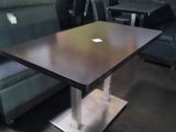 a table that has a laptop on it in a room