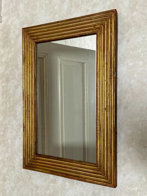 a mirror on the wall above a sink in a bathroom