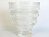 a glass vase that has a spiral design on it