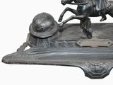 a statue of a man riding a horse with a helmet on