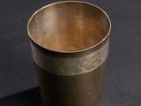 brass cup on a black background